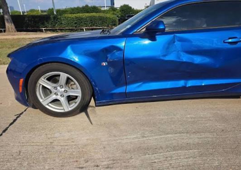 Blue coupe with side-impact collision damage